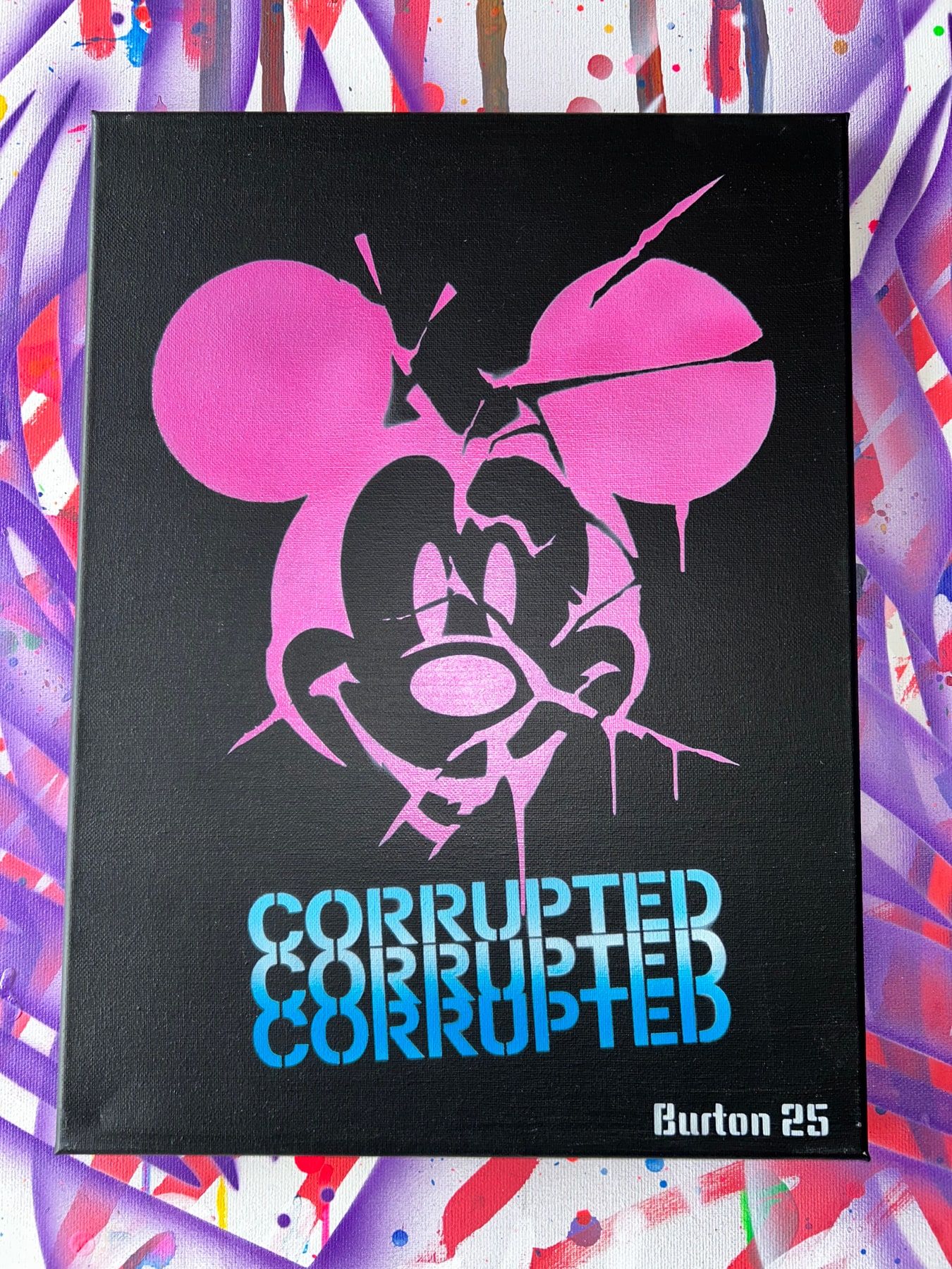 Mickey Mouse stencil in neon pink on black with Corrupted lettering.