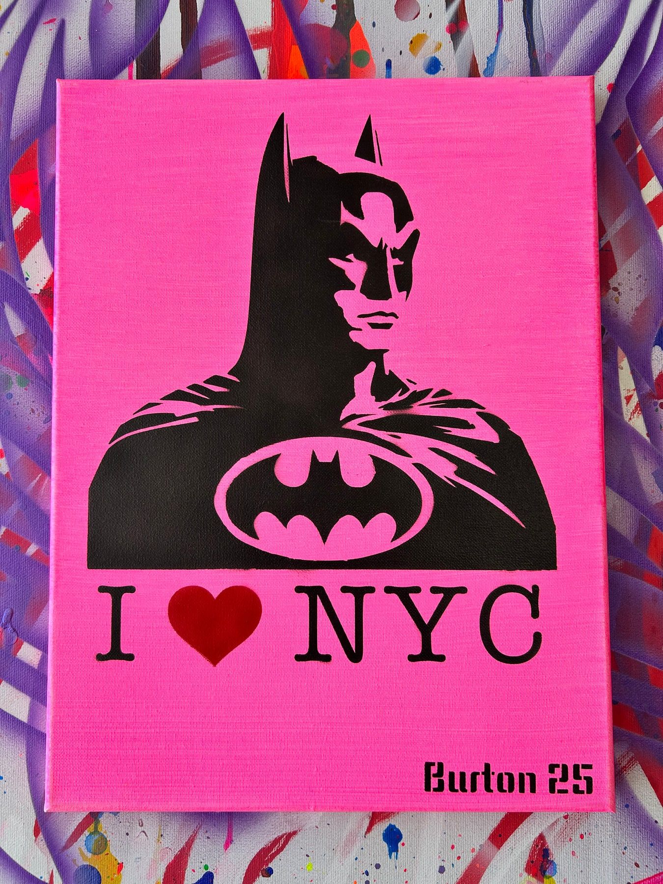 Pop art riff on I Love NY with a hooded figure and a Batman emblem, black on neon pink.