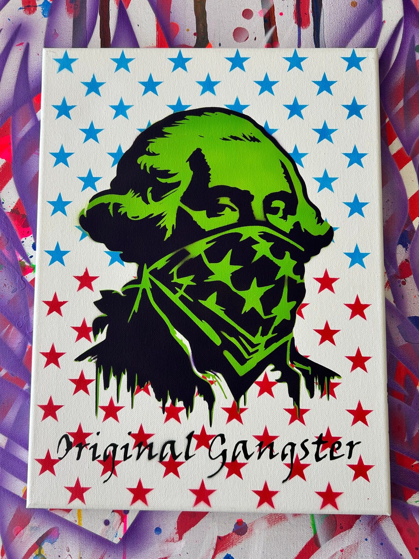Stencil of George Washington in an American-flag bandana, neon green on a red and blue star background, titled Original Gangster.