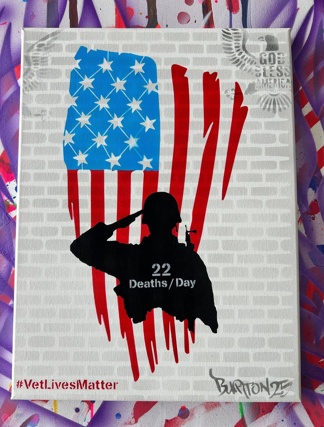 Stencil of a saluting service member over an American flag on brick, captioned 22 Deaths a Day, with #VetLivesMatter.